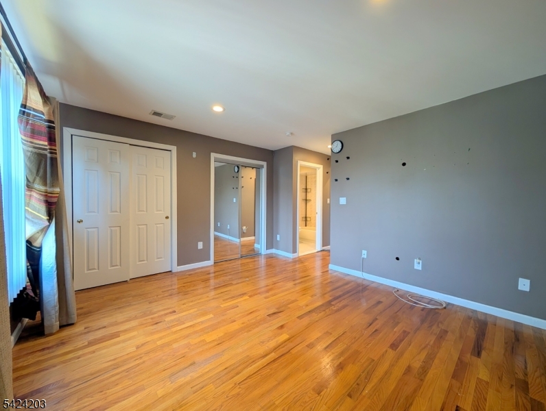 448 Fulton Street Elizabeth Port, NJ 07206 - Photo 23 of 37 a view of an empty room with window and wooden floor