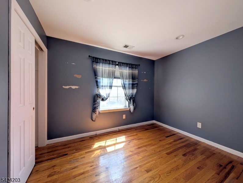 448 Fulton Street Elizabeth Port, NJ 07206 - Photo 26 of 37 a view of empty room with wooden floor and fan