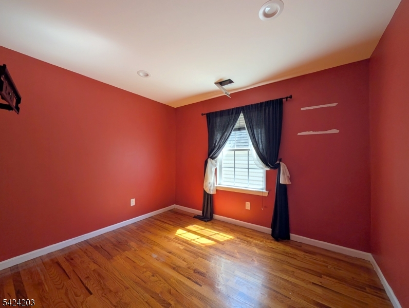 448 Fulton Street Elizabeth Port, NJ 07206 - Photo 27 of 37 a view of empty room with wooden floor and fan