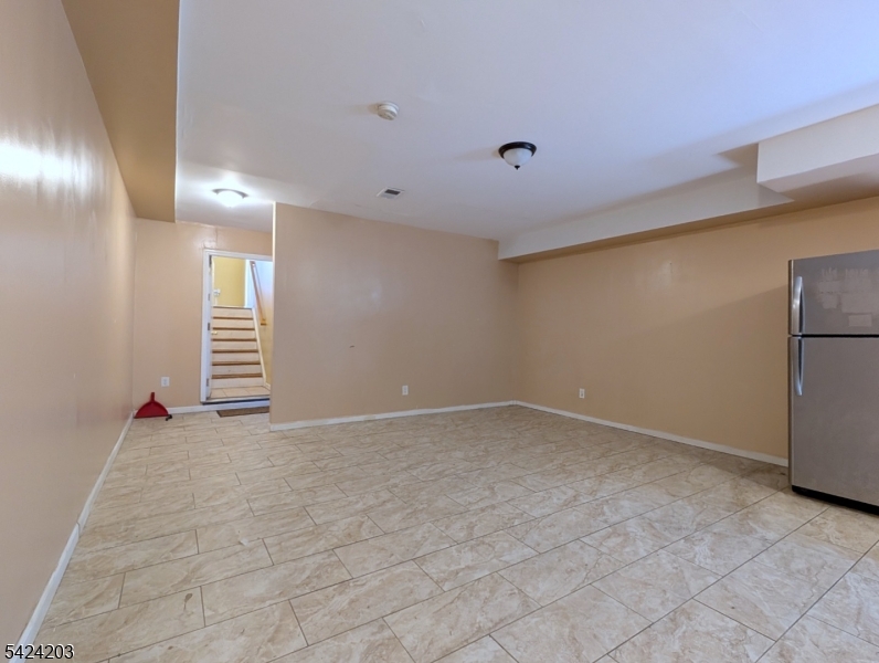 448 Fulton Street Elizabeth Port, NJ 07206 - Photo 30 of 37 a view of an empty room with a fireplace