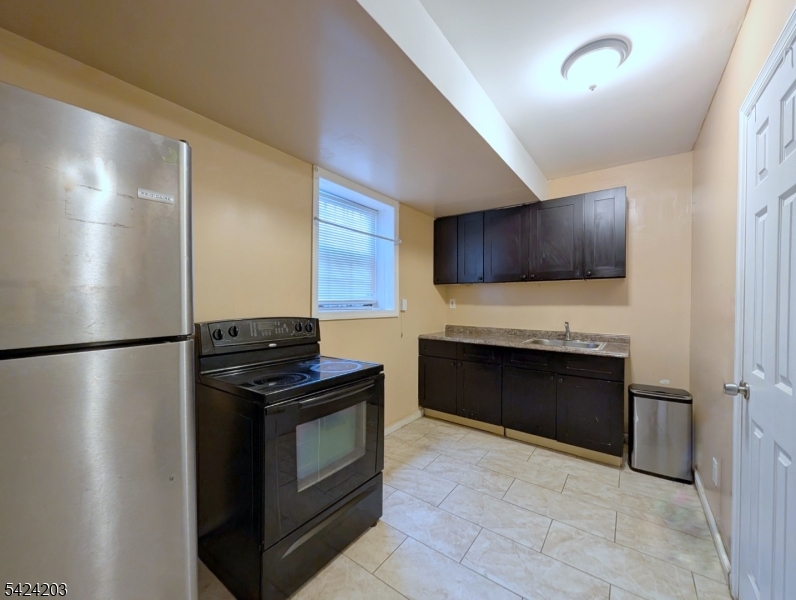 448 Fulton Street Elizabeth Port, NJ 07206 - Photo 31 of 37 a kitchen with a refrigerator stove and microwave