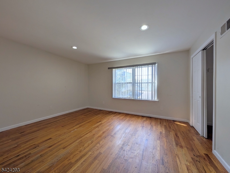448 Fulton Street Elizabeth Port, NJ 07206 - Photo 9 of 37 a view of an empty room with wooden floor and a window