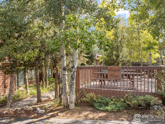 a view of a street with a house in the background