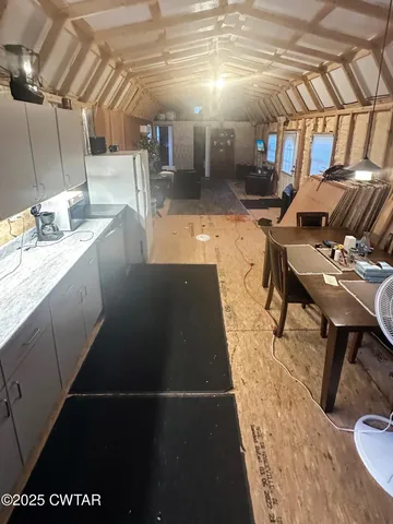 a black and white checkered floor with a kitchen view