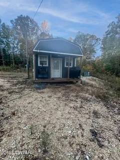 a view of house with a yard