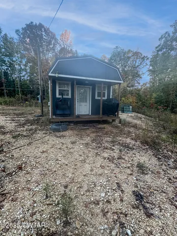a view of house with a yard
