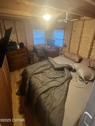 a bed sitting in a bedroom next to a window