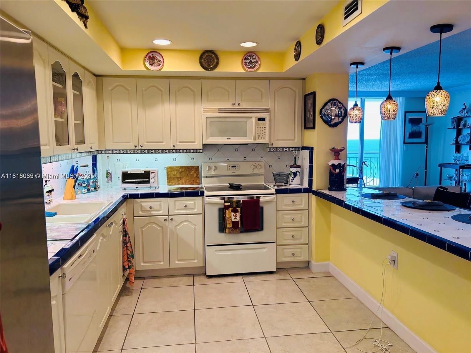 Corinthian Condominiums Miami Beach, FL 33140 - Photo 5 of 19 a kitchen with a sink window and cabinets