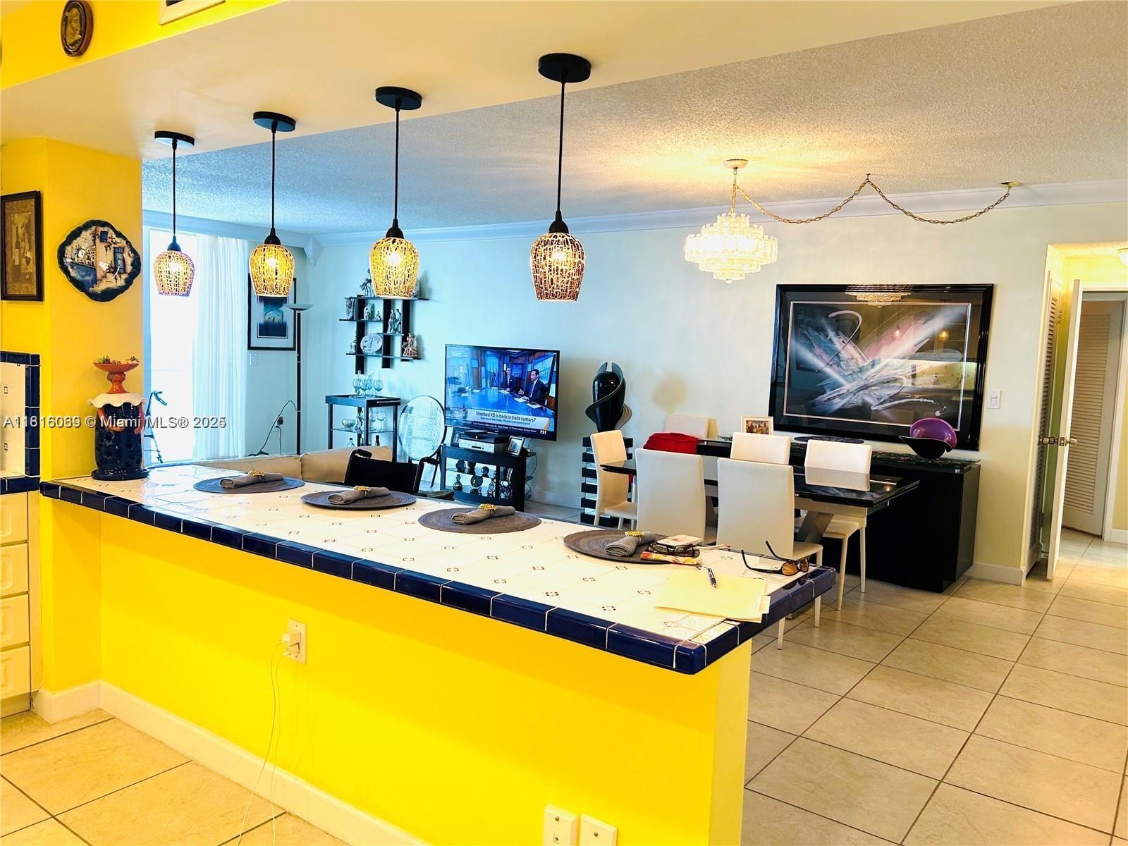 Corinthian Condominiums Miami Beach, FL 33140 - Photo 6 of 19 a kitchen area with granite countertop a stove a sink and a wooden floor