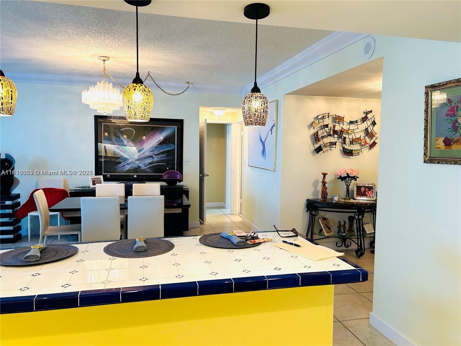 Corinthian Condominiums Miami Beach, FL 33140 - Photo 7 of 19 a room with a chandelier and a wooden floor