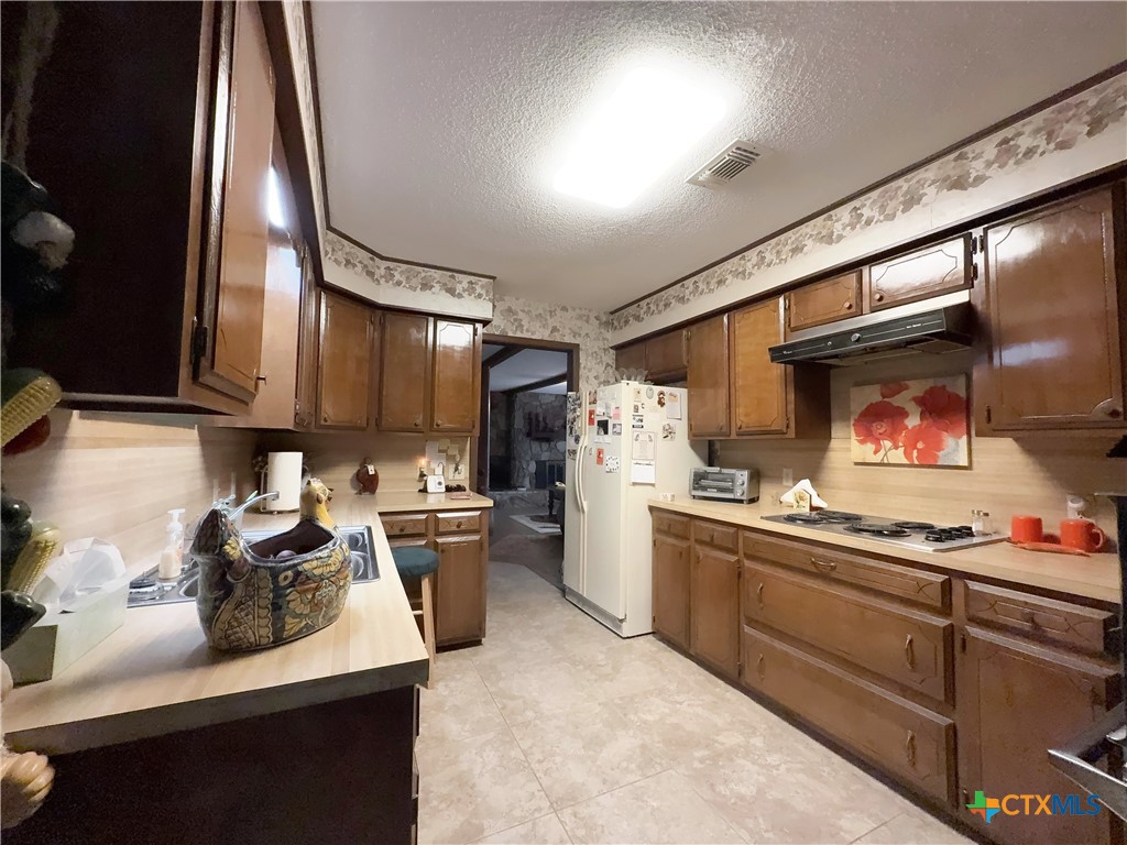 2834 Highway 238 Port Lavaca, TX 77979 - Photo 13 of 45 a kitchen with stainless steel appliances granite countertop a sink stove and refrigerator