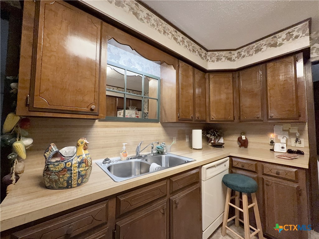 2834 Highway 238 Port Lavaca, TX 77979 - Photo 16 of 45 a kitchen with sink cabinets and stove top oven