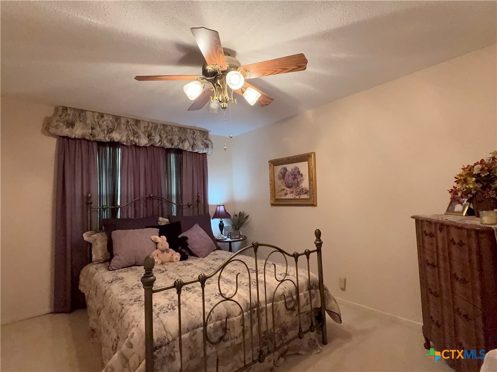 2834 Highway 238 Port Lavaca, TX 77979 - Photo 24 of 45 a bedroom with bed and a chandelier