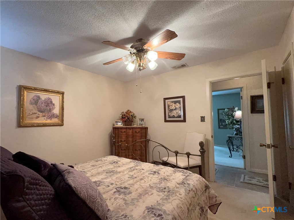 2834 Highway 238 Port Lavaca, TX 77979 - Photo 25 of 45 a bedroom with a bed and a chandelier