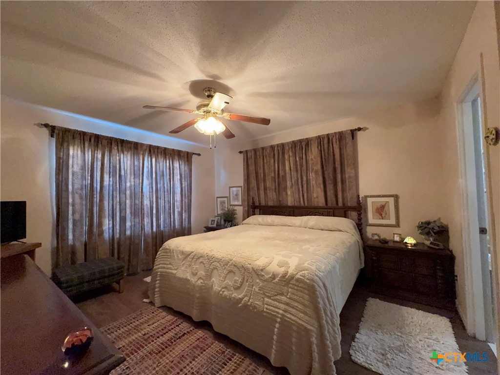 2834 Highway 238 Port Lavaca, TX 77979 - Photo 26 of 45 a bedroom with a bed and a chandelier