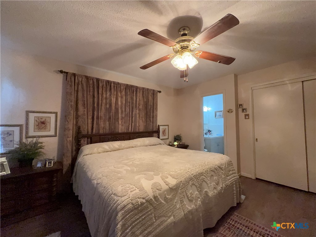 2834 Highway 238 Port Lavaca, TX 77979 - Photo 28 of 45 a bedroom with a large bed and a chandelier