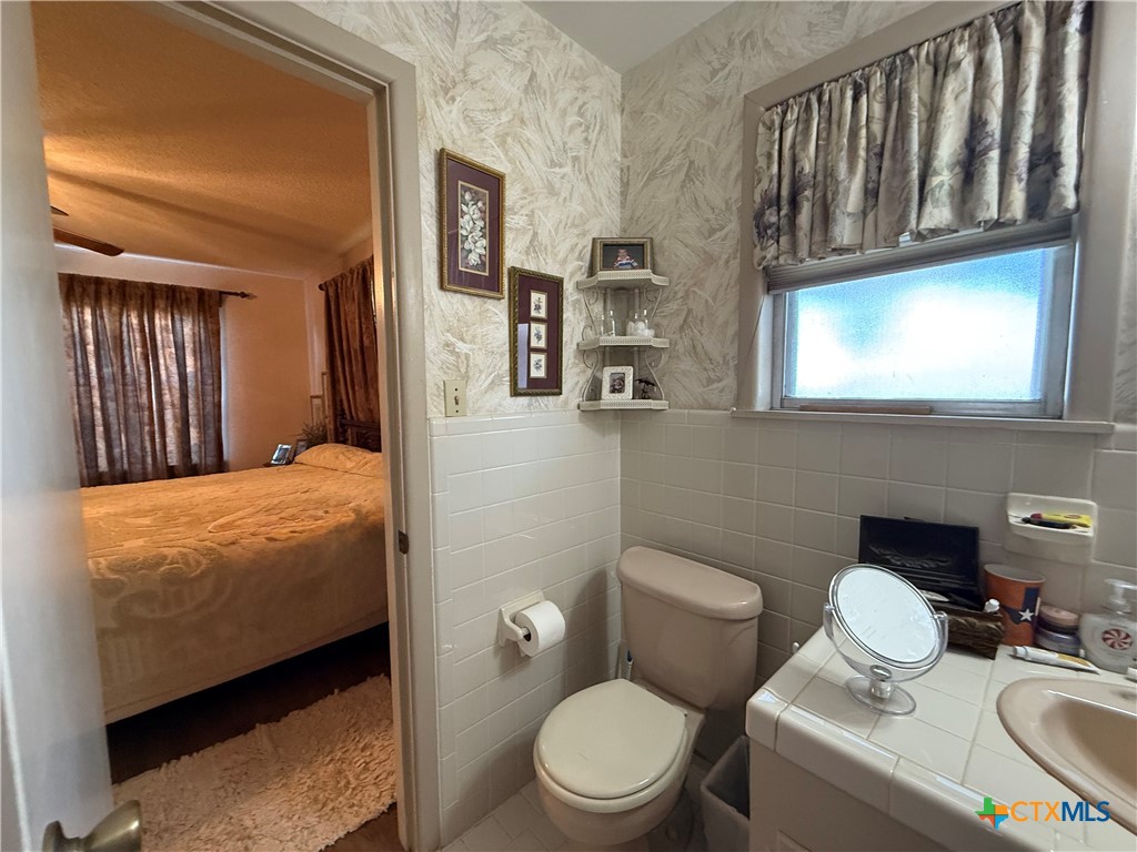 2834 Highway 238 Port Lavaca, TX 77979 - Photo 31 of 45 a bathroom with a toilet sink and mirror