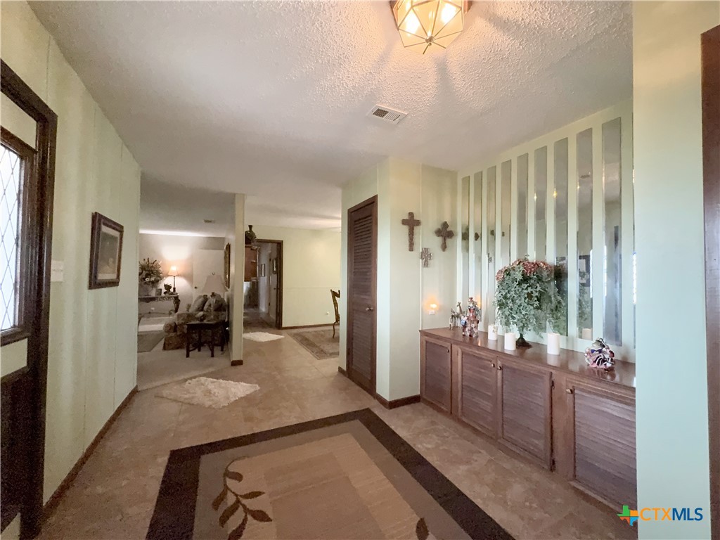 2834 Highway 238 Port Lavaca, TX 77979 - Photo 8 of 45 a room with lots of wooden furniture and potted plant