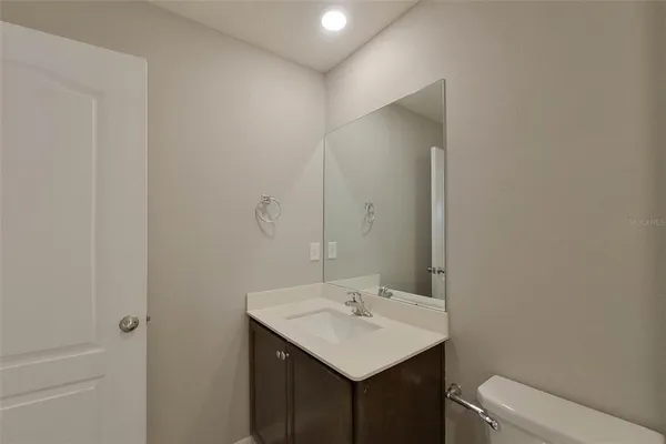 a bathroom with a sink a toilet and vanity