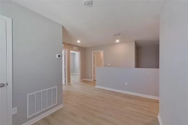 a view of hallway with wooden floor