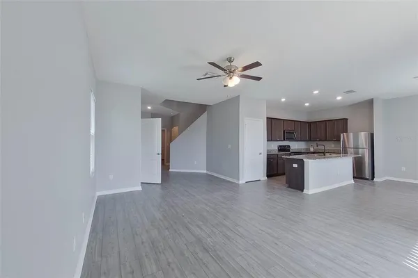 a view of kitchen with refrigerator and microwave