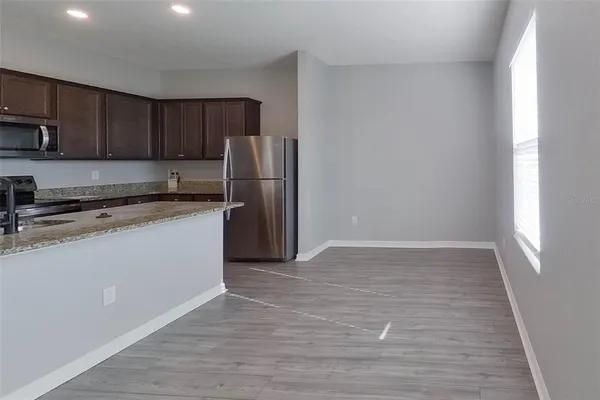 a kitchen with a refrigerator sink and cabinets