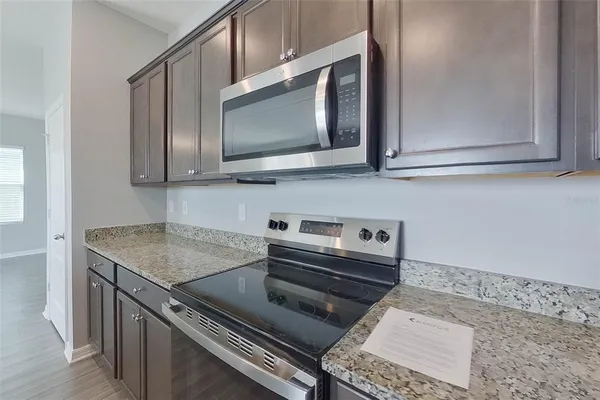 a kitchen with a stove microwave and sink