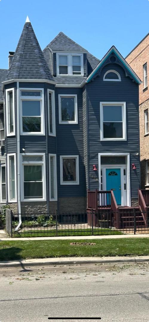 5138 South Wabash Avenue, Unit 3 Chicago, IL 60615 - Photo 1 of 5 a front view of a house with a yard