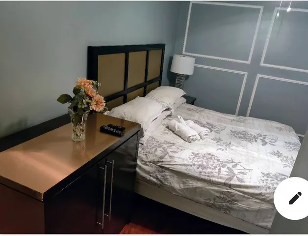 a bedroom with a sink and a mirror