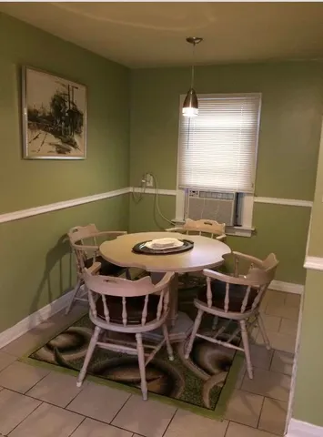 a view of a dining room with furniture and window