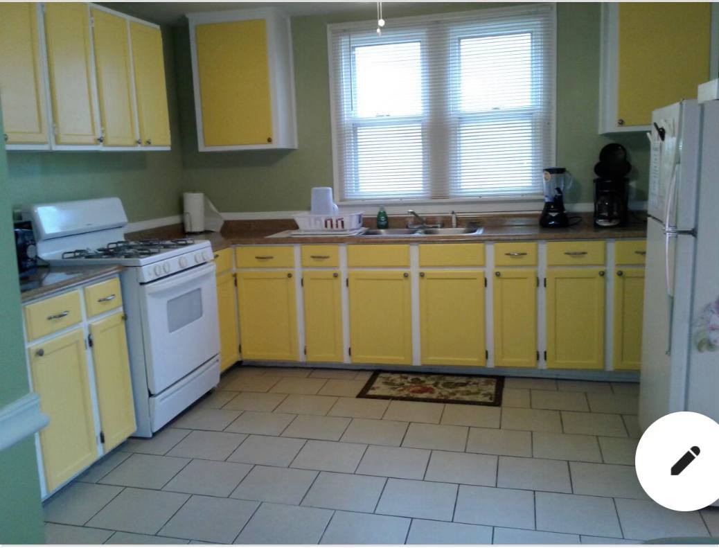 5138 South Wabash Avenue, Unit 3 Chicago, IL 60615 - Photo 4 of 5 a kitchen with a sink a stove top oven cabinets and a window