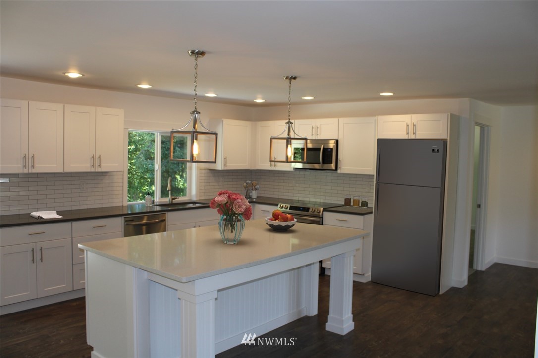 103 Eadon Road Toledo, WA 98591 - Photo 7 of 26 a kitchen with a refrigerator a sink a stove a microwave and cabinets