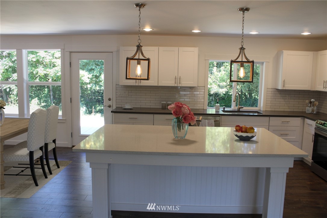 103 Eadon Road Toledo, WA 98591 - Photo 9 of 26 a kitchen with a table chairs and wooden floor