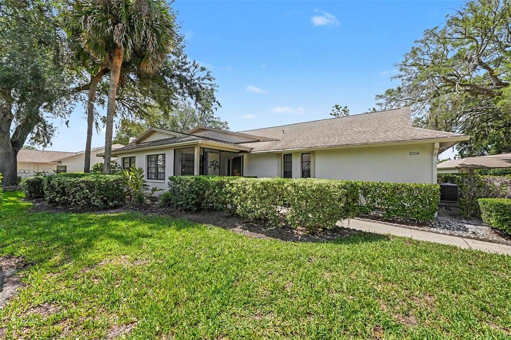 9204 Golf View Drive New Port Richey, FL 34655 - Photo 4 of 33 front view of a house with a yard