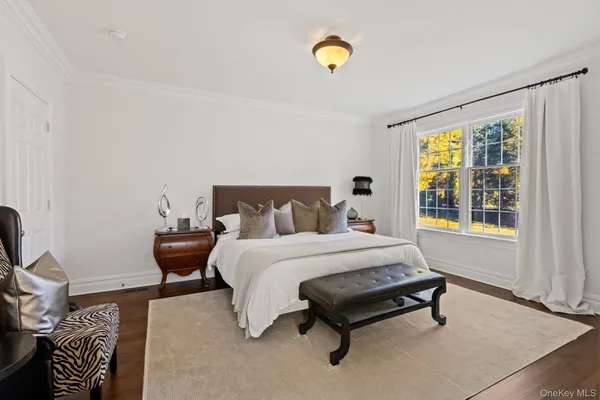 a spacious bedroom with a bed and a window