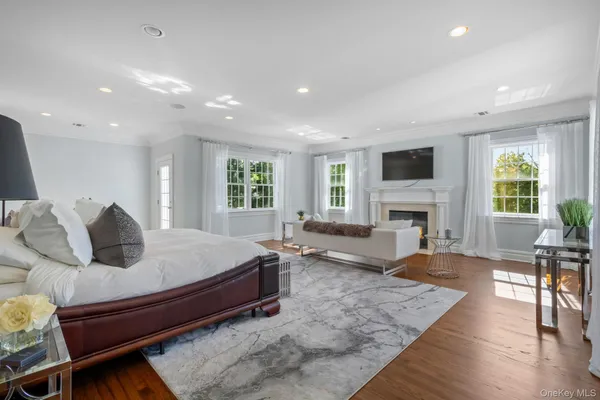 a living room with furniture a large window and a fireplace