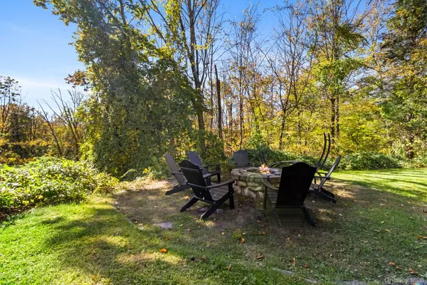 a view of a backyard with table and chairs and potted plants