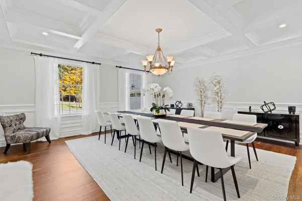 a dining room with wooden floor and breakfast area
