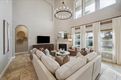 a living room with furniture a fireplace and a mirror
