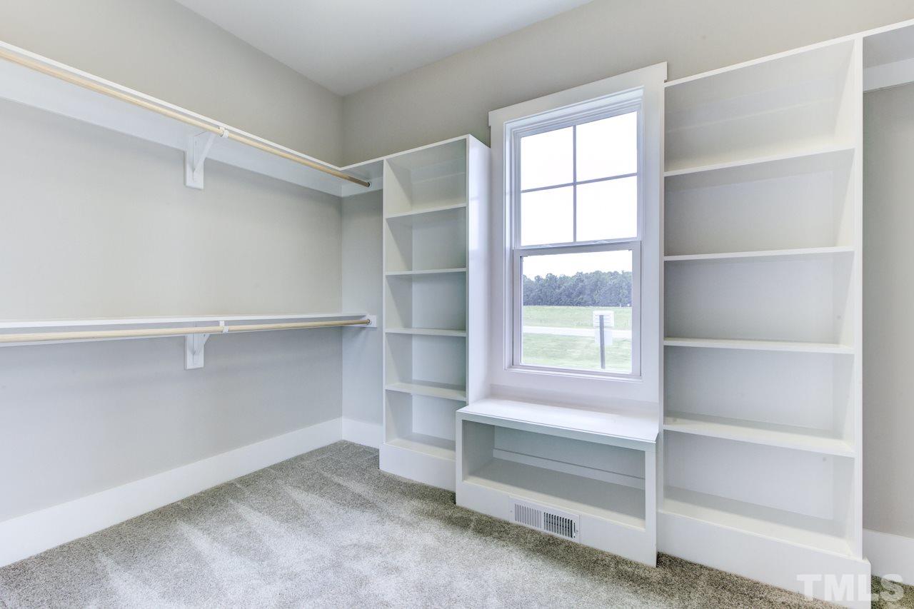 1033 Sky Wave Trail, Unit 8 Raleigh, NC 27603 - Photo 12 of 23 a view of walk in closet with empty racks