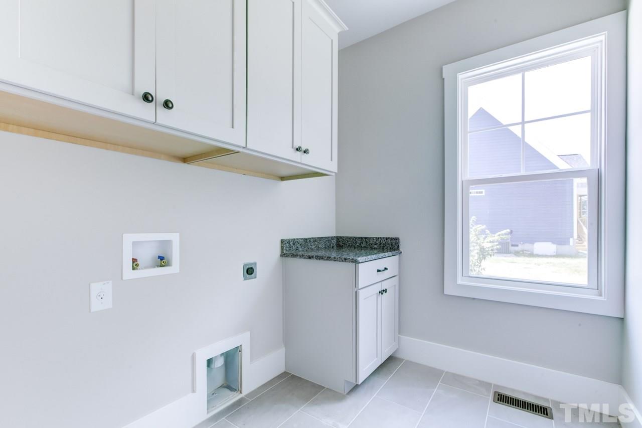 1033 Sky Wave Trail, Unit 8 Raleigh, NC 27603 - Photo 13 of 23 a kitchen with white cabinets and window