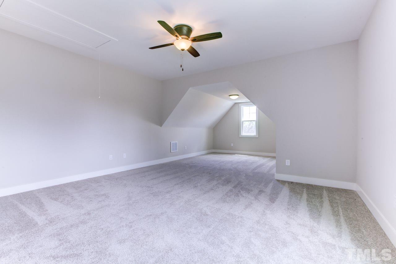 1033 Sky Wave Trail, Unit 8 Raleigh, NC 27603 - Photo 14 of 23 an empty room with a ceiling fan and a window