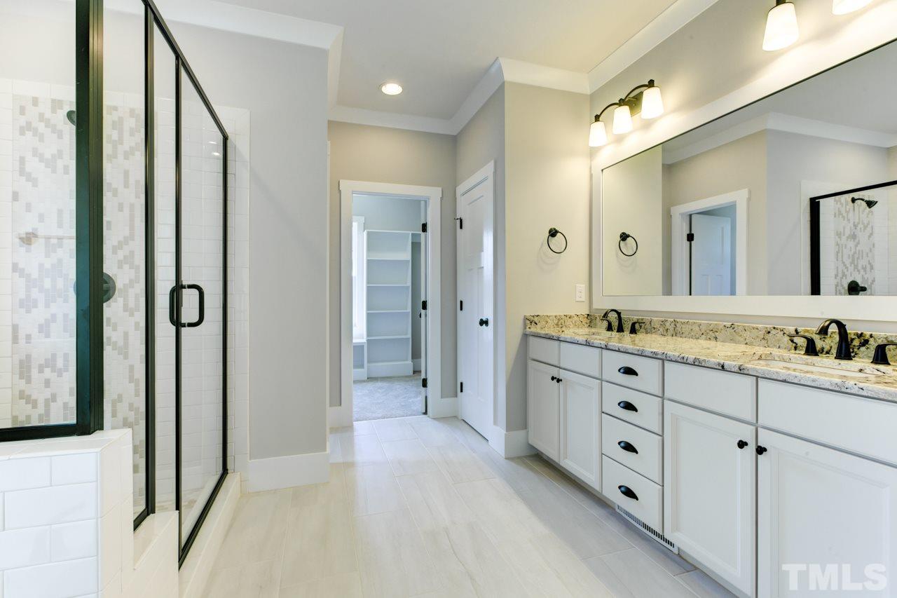 1033 Sky Wave Trail, Unit 8 Raleigh, NC 27603 - Photo 18 of 23 a bathroom with a granite countertop sink mirror and a