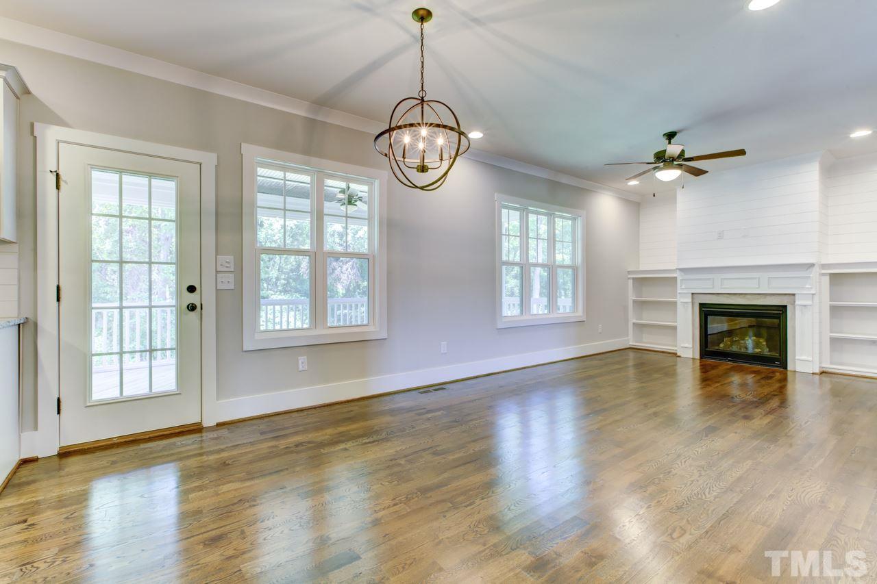 1033 Sky Wave Trail, Unit 8 Raleigh, NC 27603 - Photo 5 of 23 a view of an room with wooden floor fireplace and windows