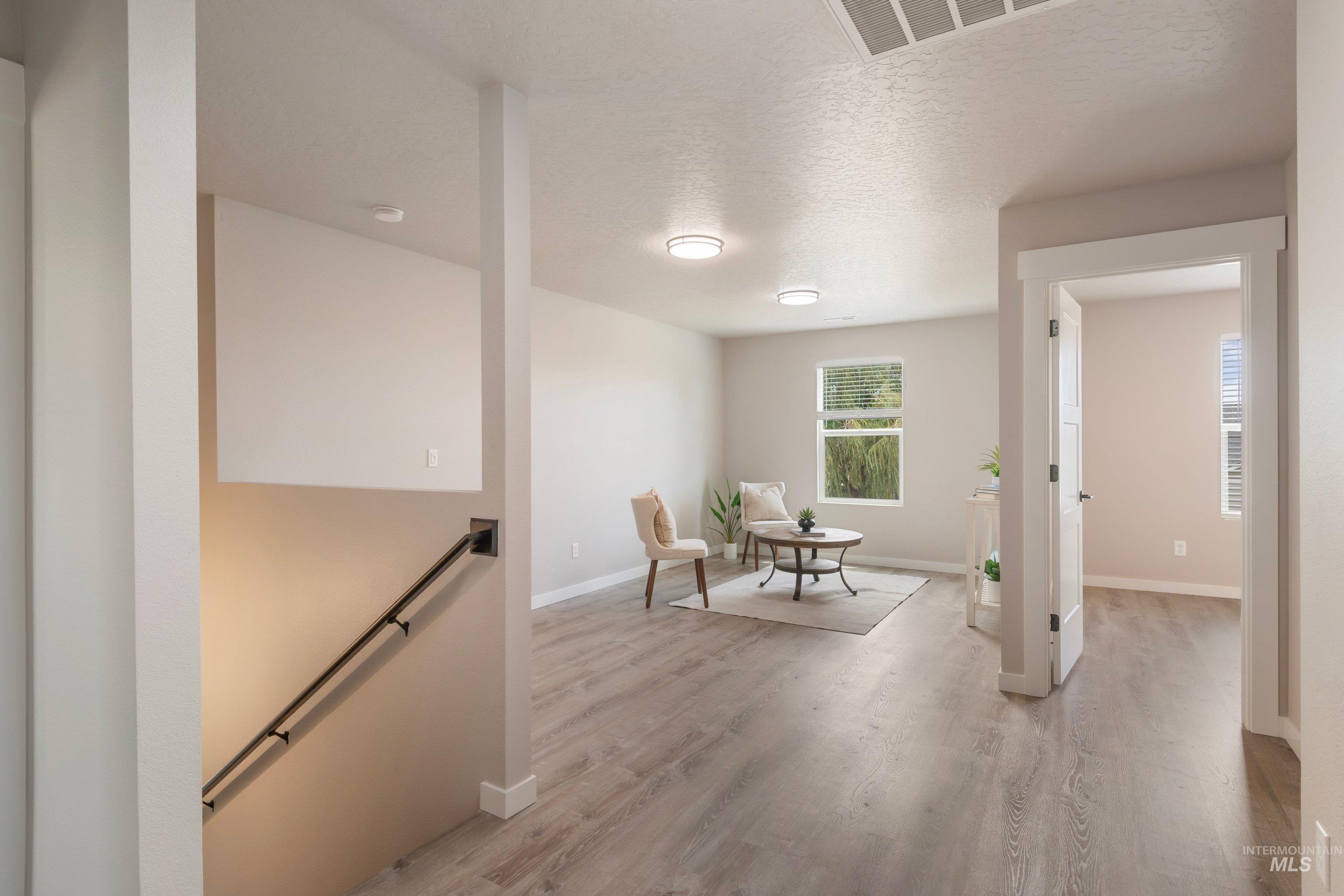 16759 Abram Avenue Caldwell, ID 83607 - Photo 24 of 33 Spacious interior featuring wood-finish flooring, abundant natural light from multiple windows, recessed ceiling lights, and contemporary light gray wall tones