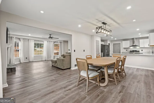 a view of a dining room with furniture and wooden floor