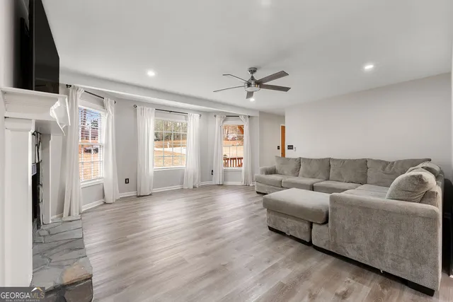 a living room with furniture and a large window