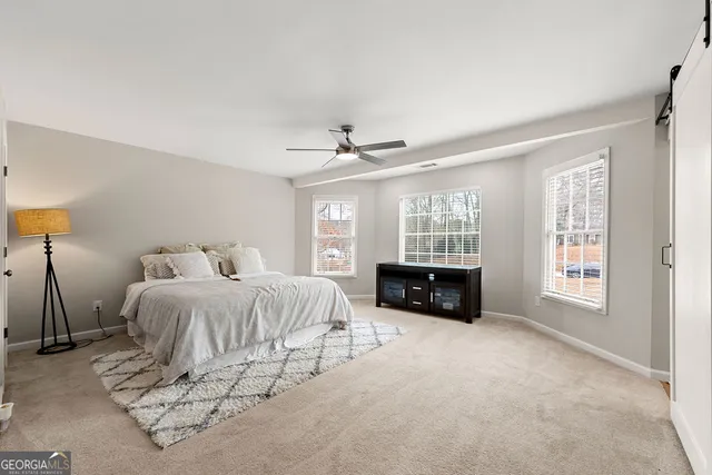 a spacious bedroom with a bed and a window