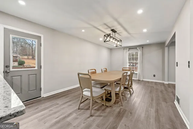 a view of a dining room with furniture window and wooden floor