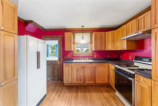 a kitchen with a sink appliances and cabinets